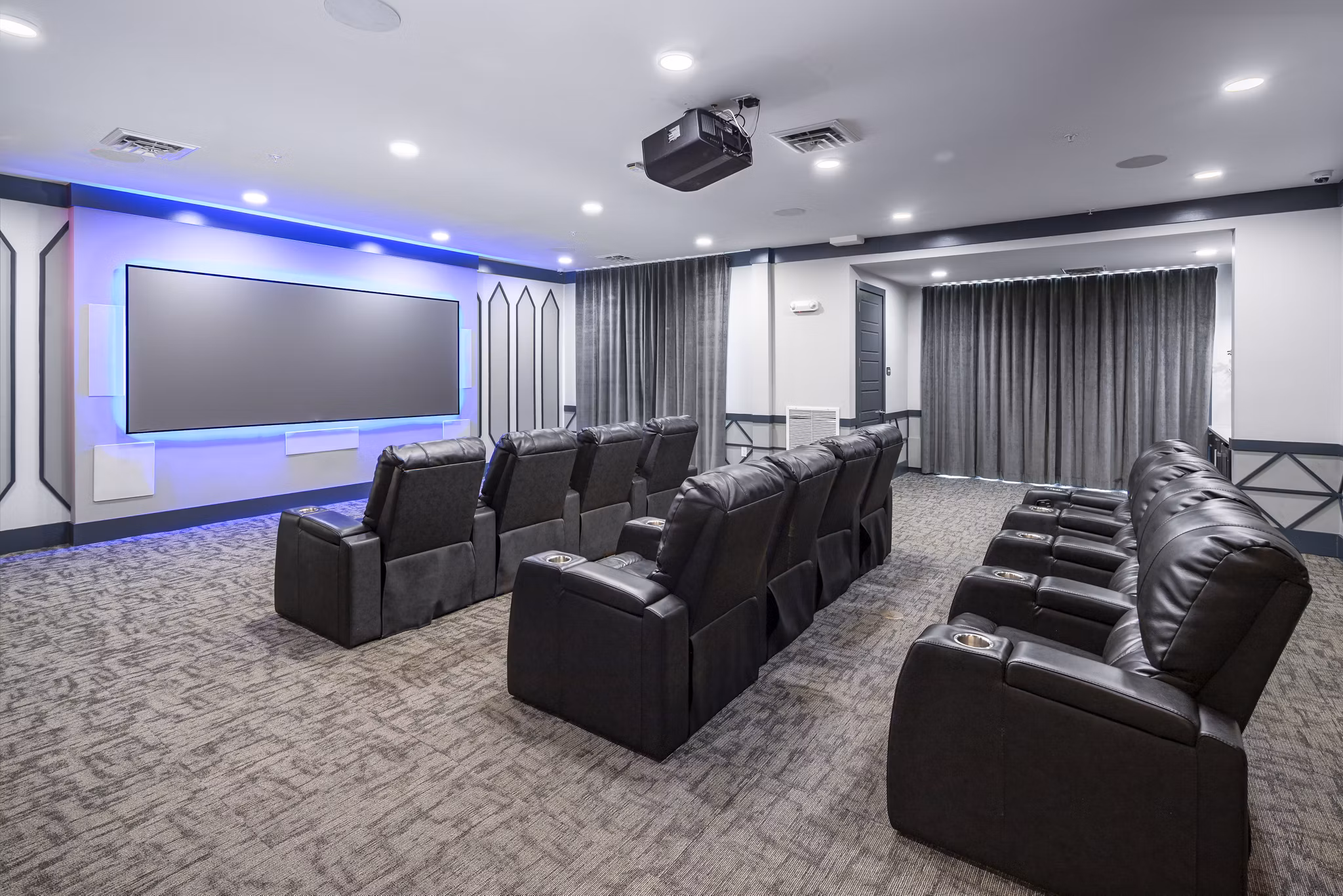 Clubhouse theater with plush seating at Sterling at Stonecrest Apartments, ideal for movie nights and social gatherings