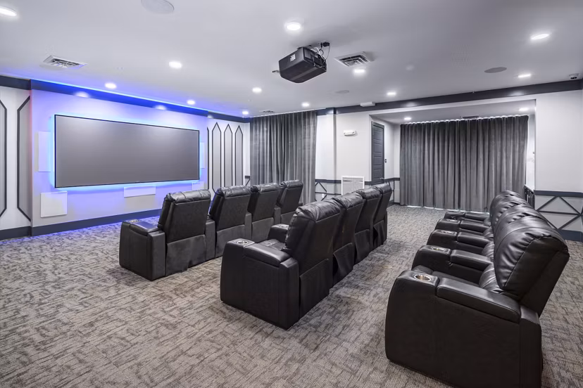 Clubhouse theater with plush seating at Sterling at Stonecrest Apartments, ideal for movie nights and social gatherings