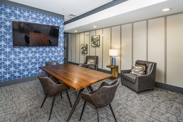 Sterling at Stonecrest: Modern clubhouse meeting facility with elegant design and comfortable seating, perfect for residents' gatherings