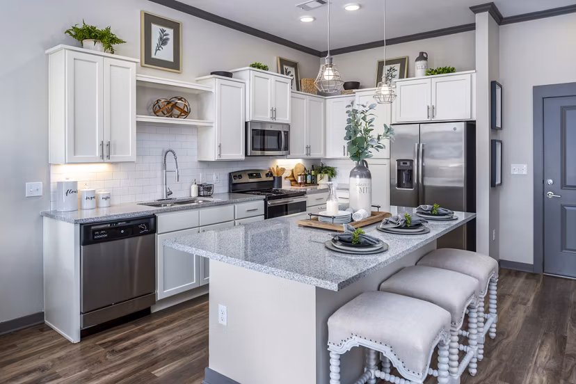 Modern kitchen with stainless steel appliances in Sterling at Stonecrest Apartments, featuring luxury finishes and ample counter space