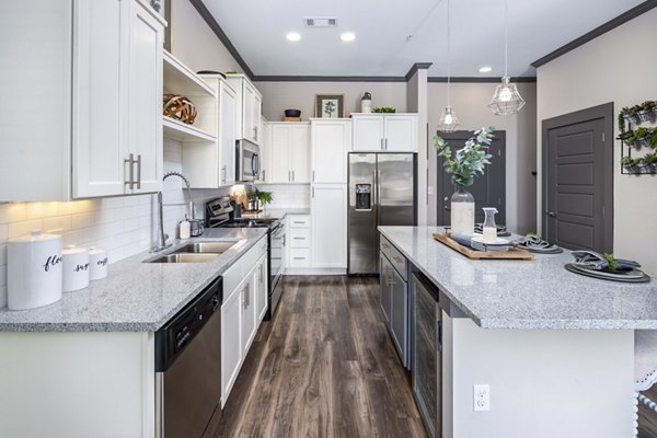 Modern kitchen with stainless steel appliances at Sterling at Stonecrest Apartments