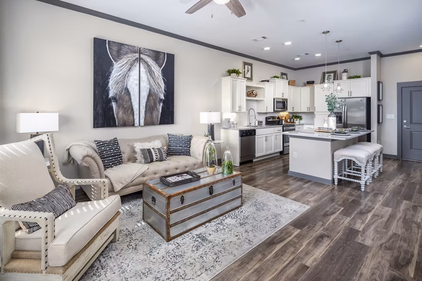 Contemporary living room with plush seating and natural light at Sterling at Stonecrest Apartments