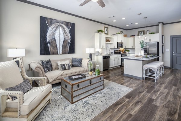Contemporary living room with plush seating and natural light at Sterling at Stonecrest Apartments
