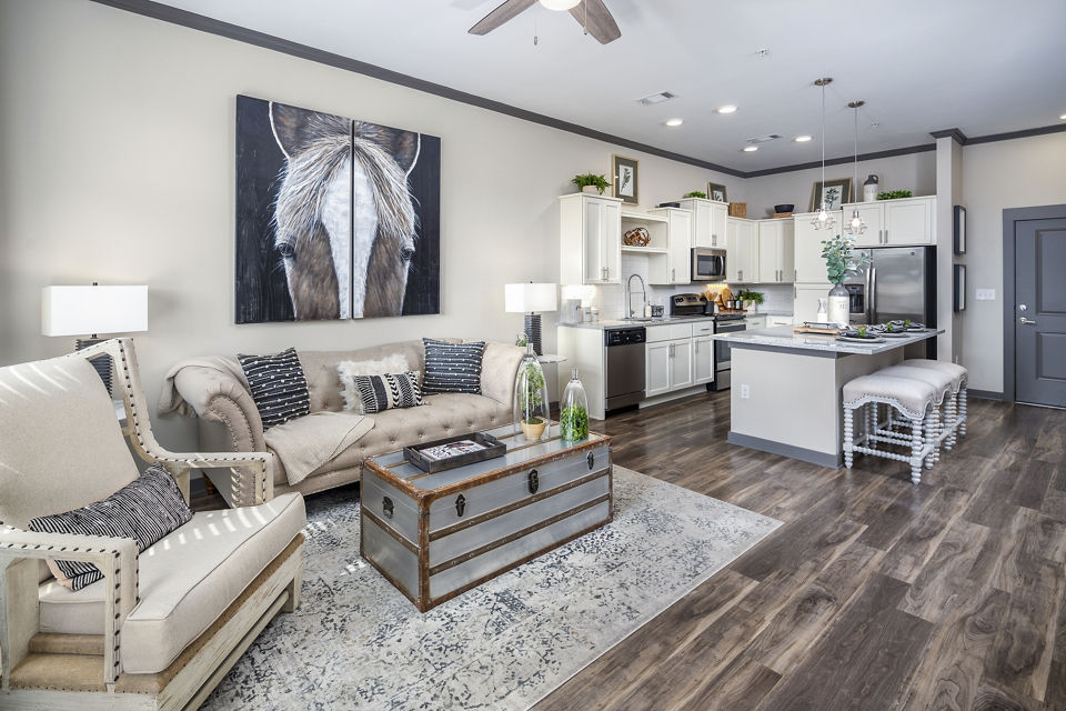 Contemporary living room with plush seating and natural light at Sterling at Stonecrest Apartments