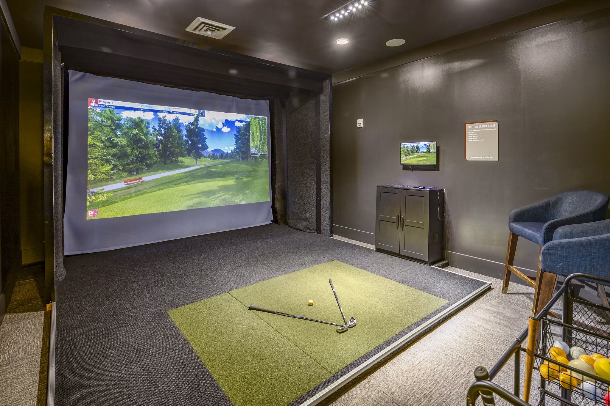 Indoor virtual golf driving range at Sterling at Stonecrest, offering luxury amenities for residents seeking an innovative golfing experience