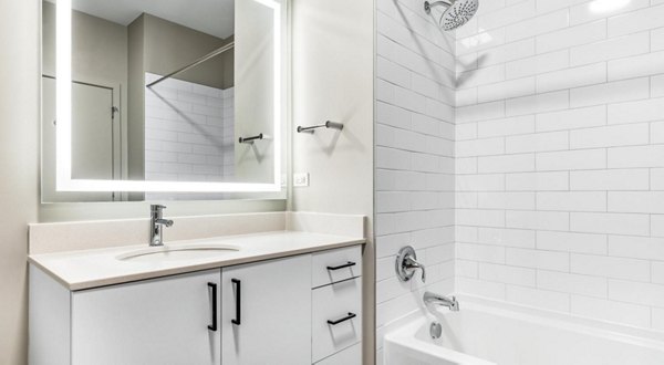 Bathroom with sleek modern fixtures at District 1860 Apartments, luxurious urban living space