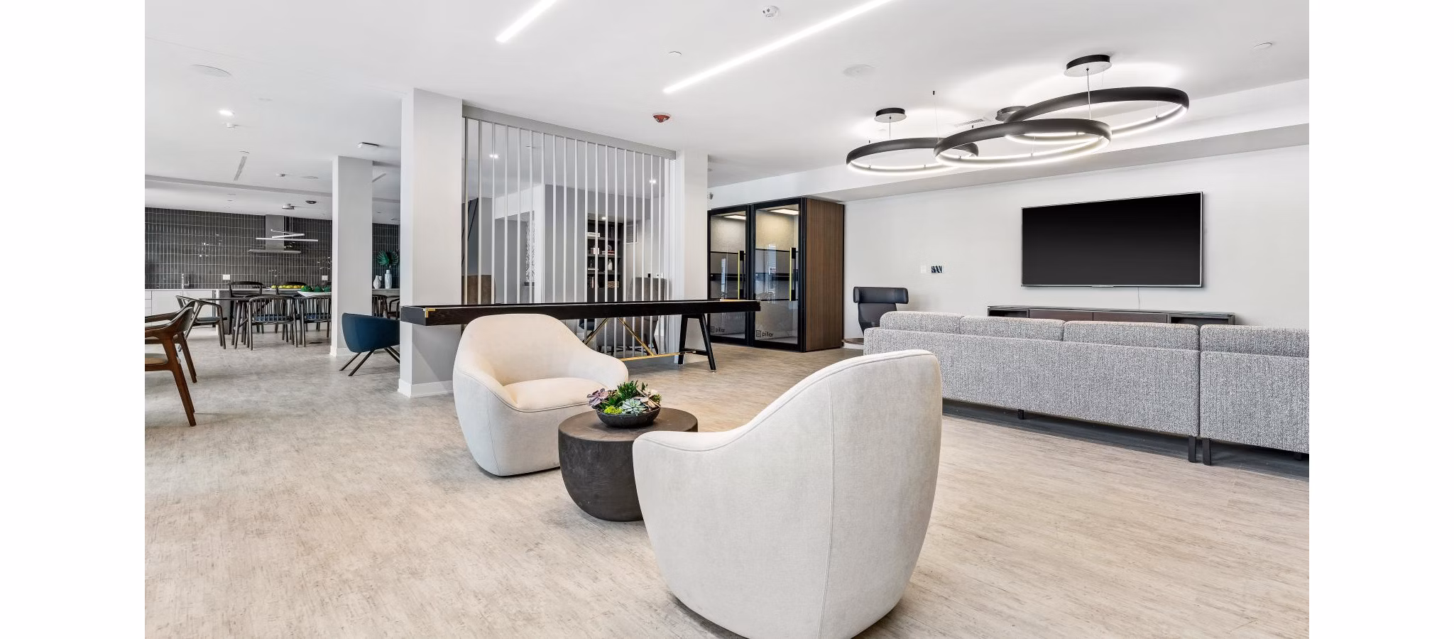 Modern clubhouse featuring spacious seating and entertainment areas at District 1860 Apartments