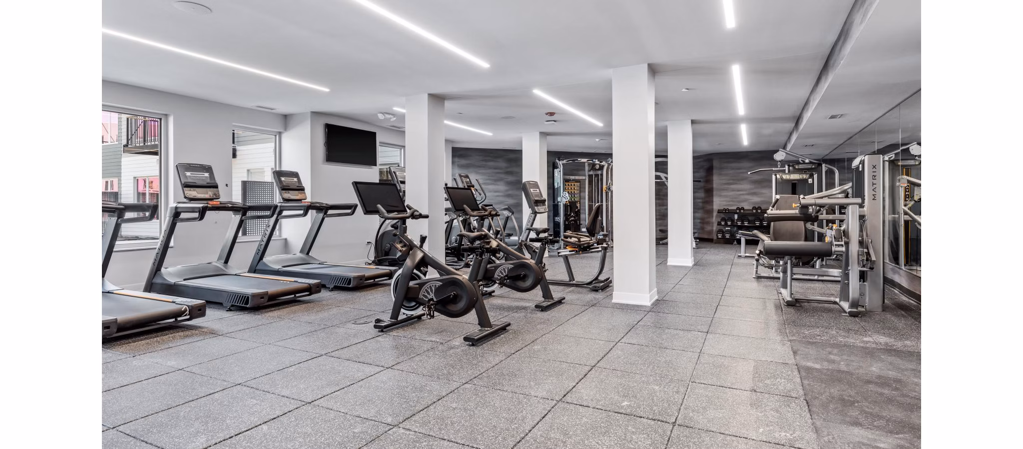 State-of-the-art fitness center with modern equipment at District 1860 Apartments