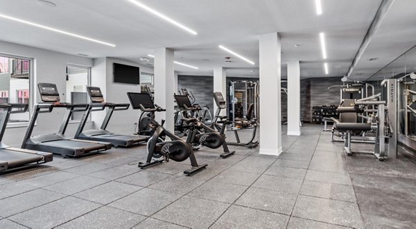 State-of-the-art fitness center with modern equipment at District 1860 Apartments