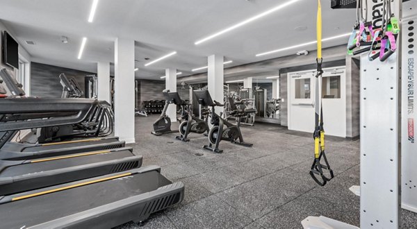 State-of-the-art fitness center at District 1860 Apartments with cardio and weight equipment for resident use