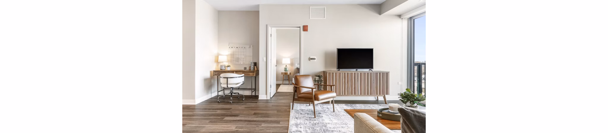 Living area with exposed brick walls and modern furnishings at San Fernando Building Apartments
