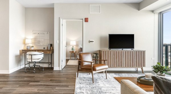 Living area with exposed brick walls and modern furnishings at San Fernando Building Apartments