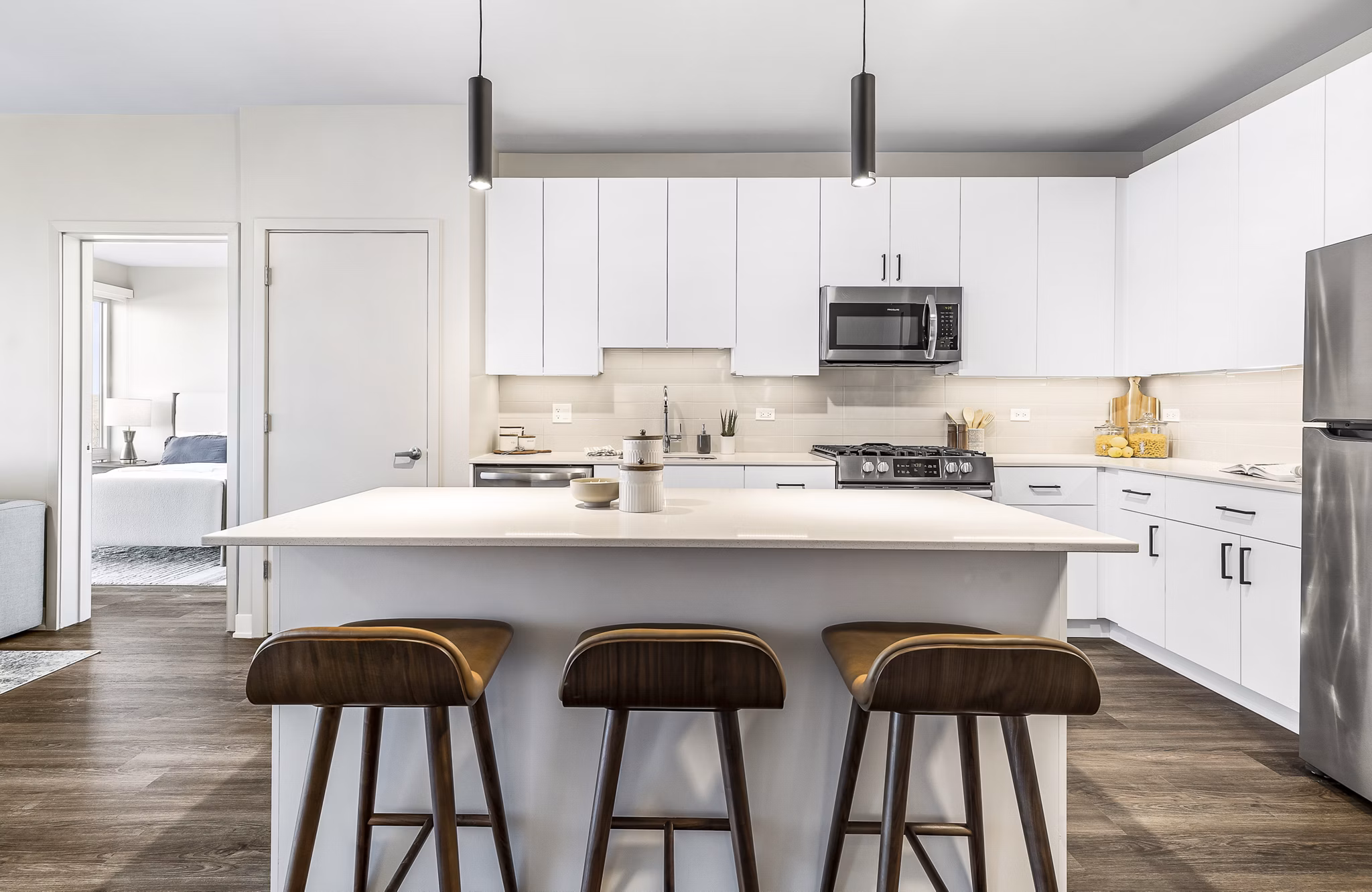 Modern living room with sleek design and ample natural light at District 1860 Apartments