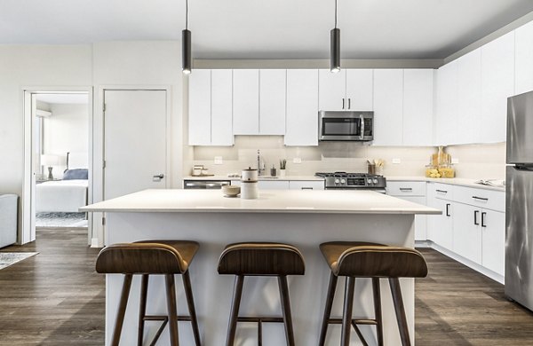 Modern living room with sleek design and ample natural light at District 1860 Apartments