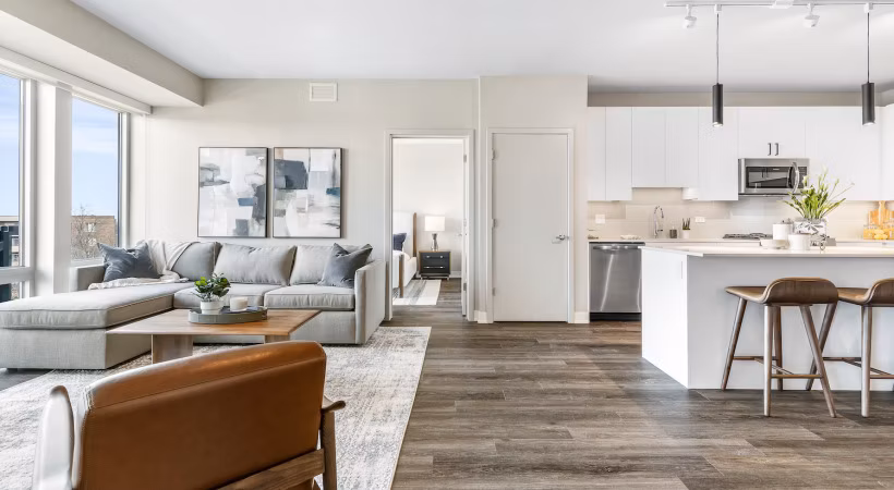 Modern kitchen featuring stainless steel appliances and quartz countertops in District 1860 Apartments