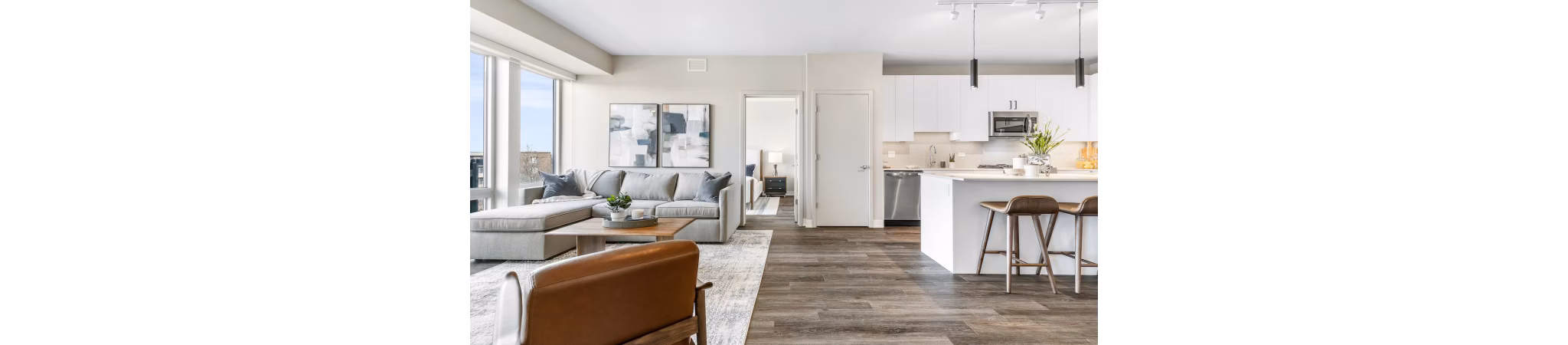 Modern kitchen featuring stainless steel appliances and quartz countertops in District 1860 Apartments