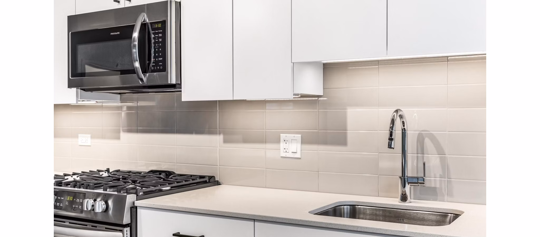 Open-plan kitchen with stainless steel appliances at District 1860 Apartments Perfect for modern living in a Greystar luxury community