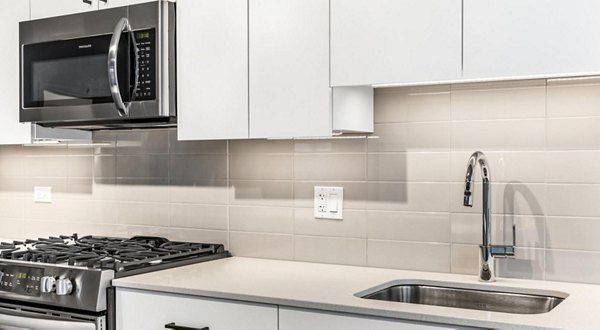 Open-plan kitchen with stainless steel appliances at District 1860 Apartments Perfect for modern living in a Greystar luxury community
