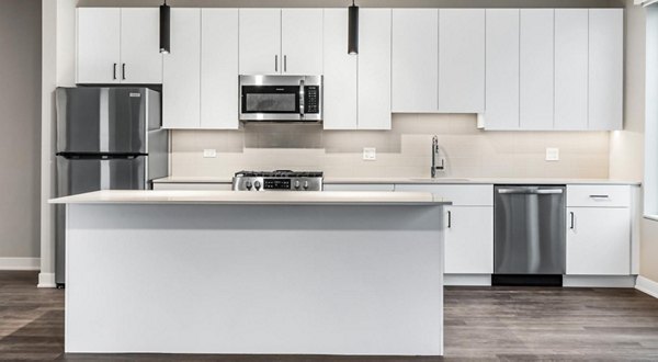 Modern kitchen with stainless steel appliances at District 1860 Apartments