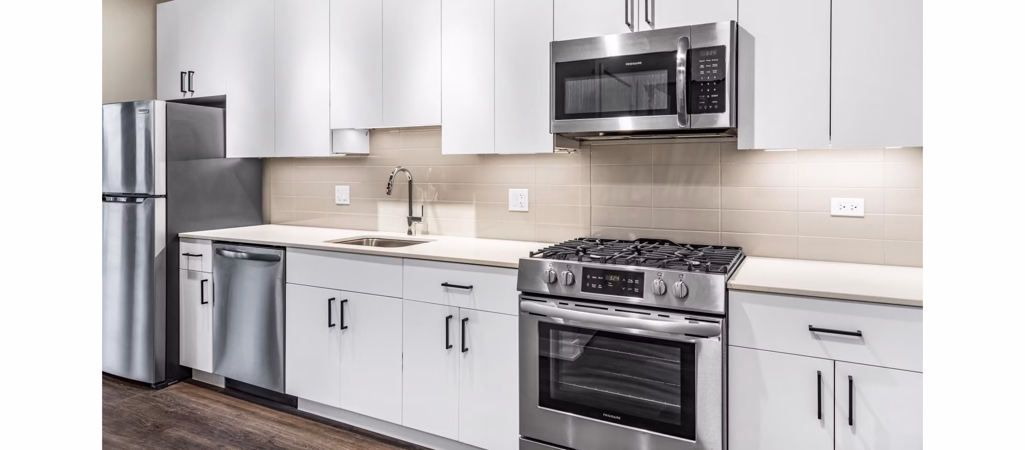 Open-concept kitchen with modern appliances at District 1860 Apartments