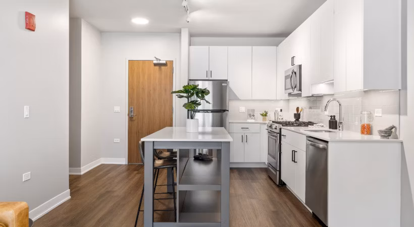 Modern kitchen with stainless steel appliances in District 1860 Apartments