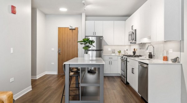 Modern kitchen with stainless steel appliances in District 1860 Apartments