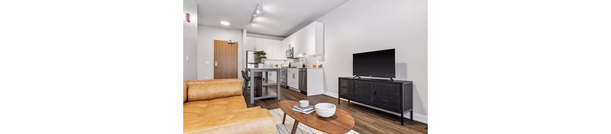 Spacious living room with modern furnishings in District 1860 Apartments, ideal for comfort and relaxation