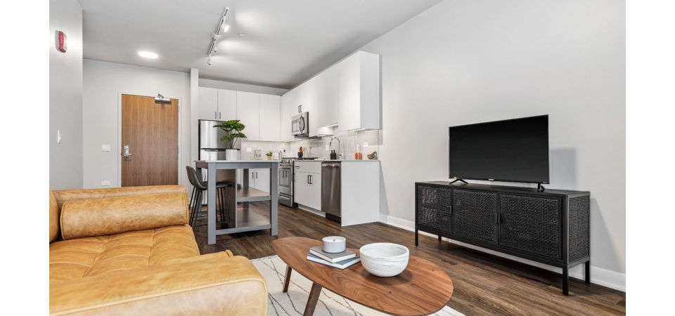 Spacious living room with modern furnishings in District 1860 Apartments, ideal for comfort and relaxation