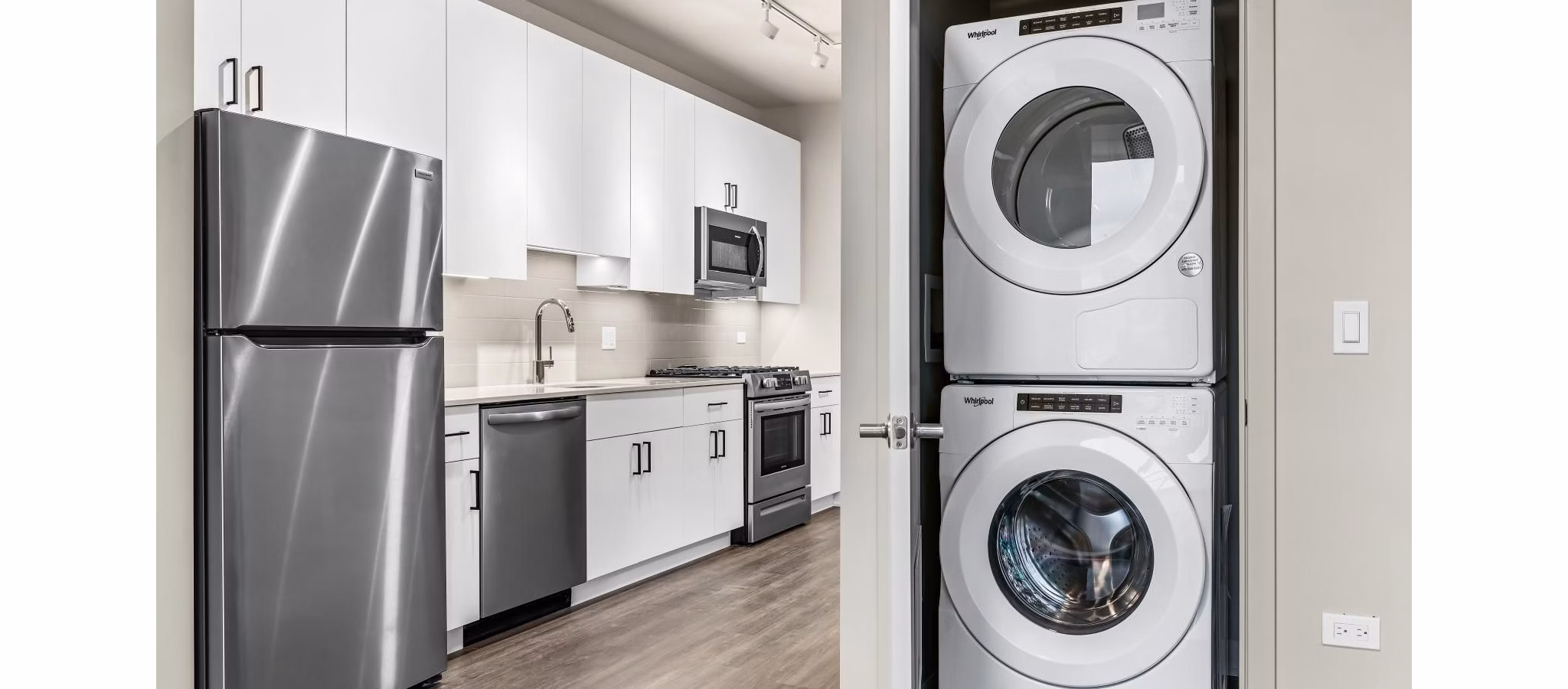 Laundry room with modern appliances at District 1860 Apartments