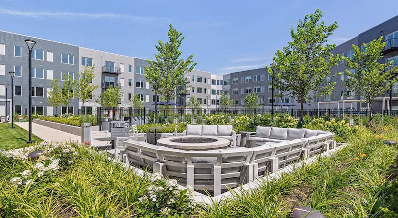 Cozy fire pit area at District 1860 Apartments, perfect for gatherings and relaxation in the heart of luxury living