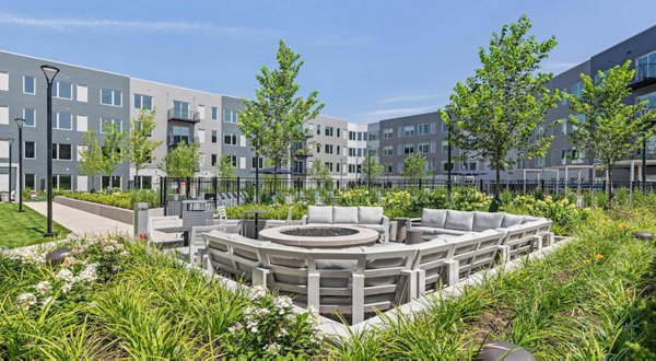 Cozy fire pit area at District 1860 Apartments, perfect for gatherings and relaxation in the heart of luxury living