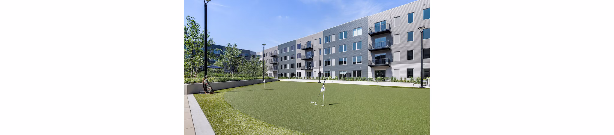Putting green at District 1860 Apartments offering leisure and recreational activities for residents