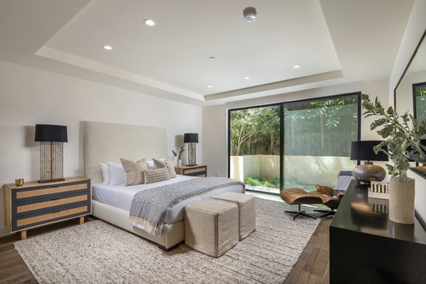 Luxury bedroom with elegant furnishings at The Alfred Apartments