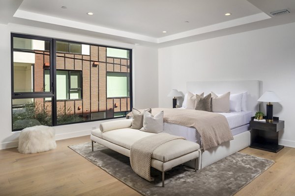 Elegant bedroom with contemporary decor at The Alfred Apartments, luxury living by Greystar