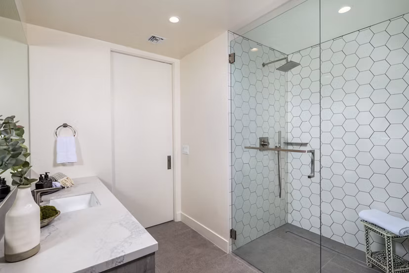 Modern bathroom featuring marble countertops and sleek fixtures at The Alfred Apartments, offering luxury living spaces in the heart of the city