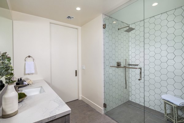 Modern bathroom featuring marble countertops and sleek fixtures at The Alfred Apartments, offering luxury living spaces in the heart of the city
