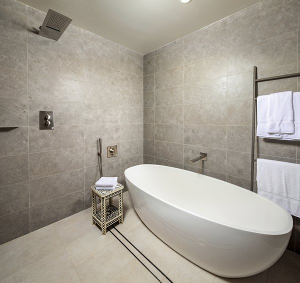 Bathroom with modern fixtures and marble countertops at The Alfred Apartments in luxury rental complex