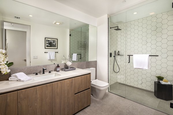 Bathroom with marble countertops and sleek fixtures at The Alfred Apartments