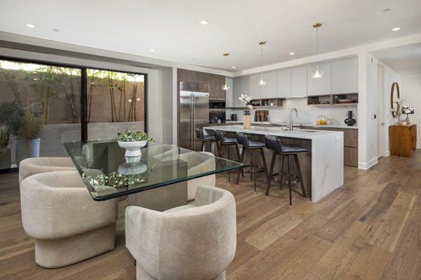 Dining area with elegant lighting and modern furniture at The Alfred Apartments, luxury living spaces for discerning residents