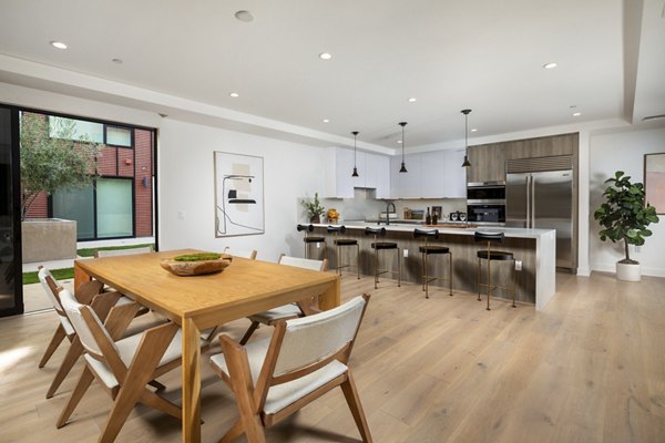 Modern dining area with elegant furnishings at The Alfred Apartments in a luxury Greystar community