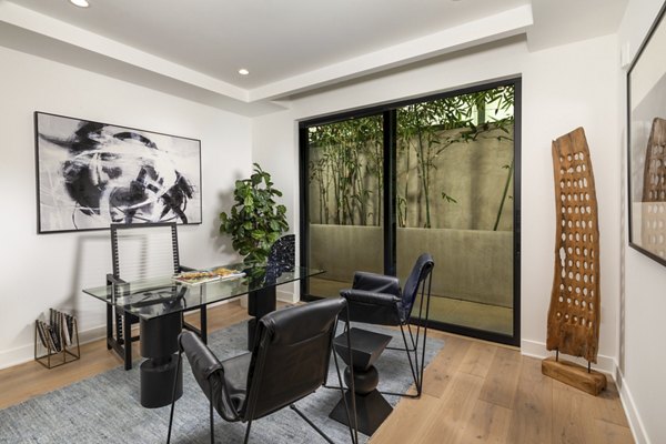 Home office with stylish decor and large desk in The Alfred Apartments, luxury living by Greystar