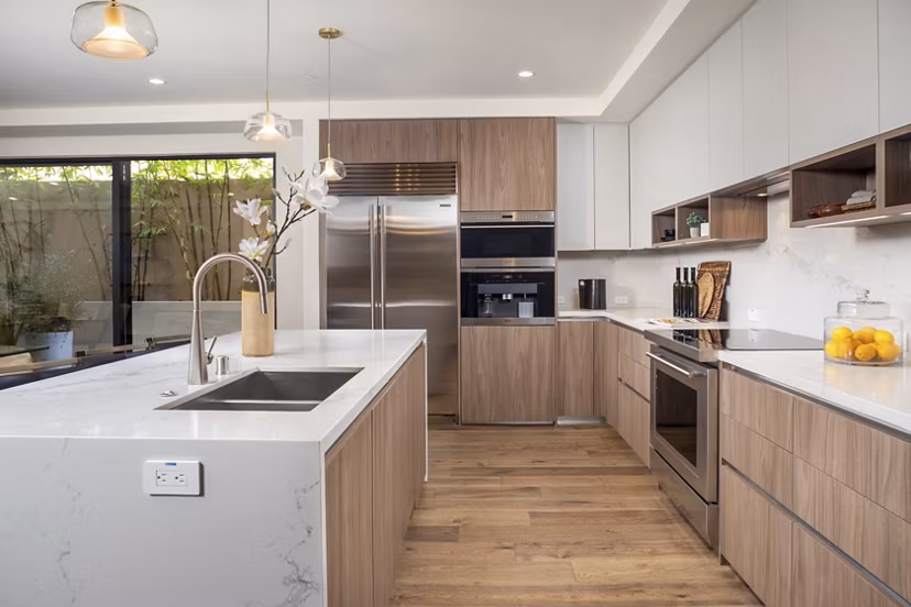 Modern kitchen with sleek cabinetry and stainless-steel appliances at The Alfred Apartments