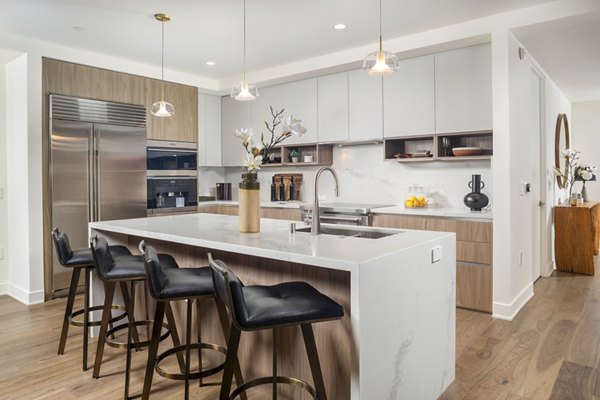 Modern kitchen with stainless steel appliances in The Alfred Apartments