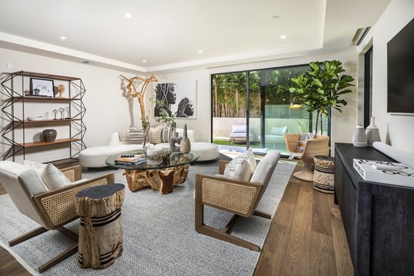 Interior Living Room: Modern living room with stylish decor and large windows at The Alfred Apartments, a Greystar luxury property