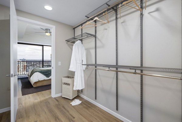 Spacious bedroom closet with ample storage and hardwood floors at 400H Apartments, a luxury Greystar property in a prime location