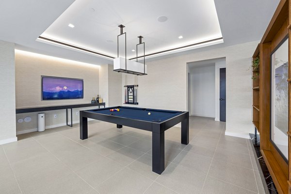 Clubhouse game room featuring billiards and lounge seating at 400H Apartments, luxury living by Greystar in a vibrant community