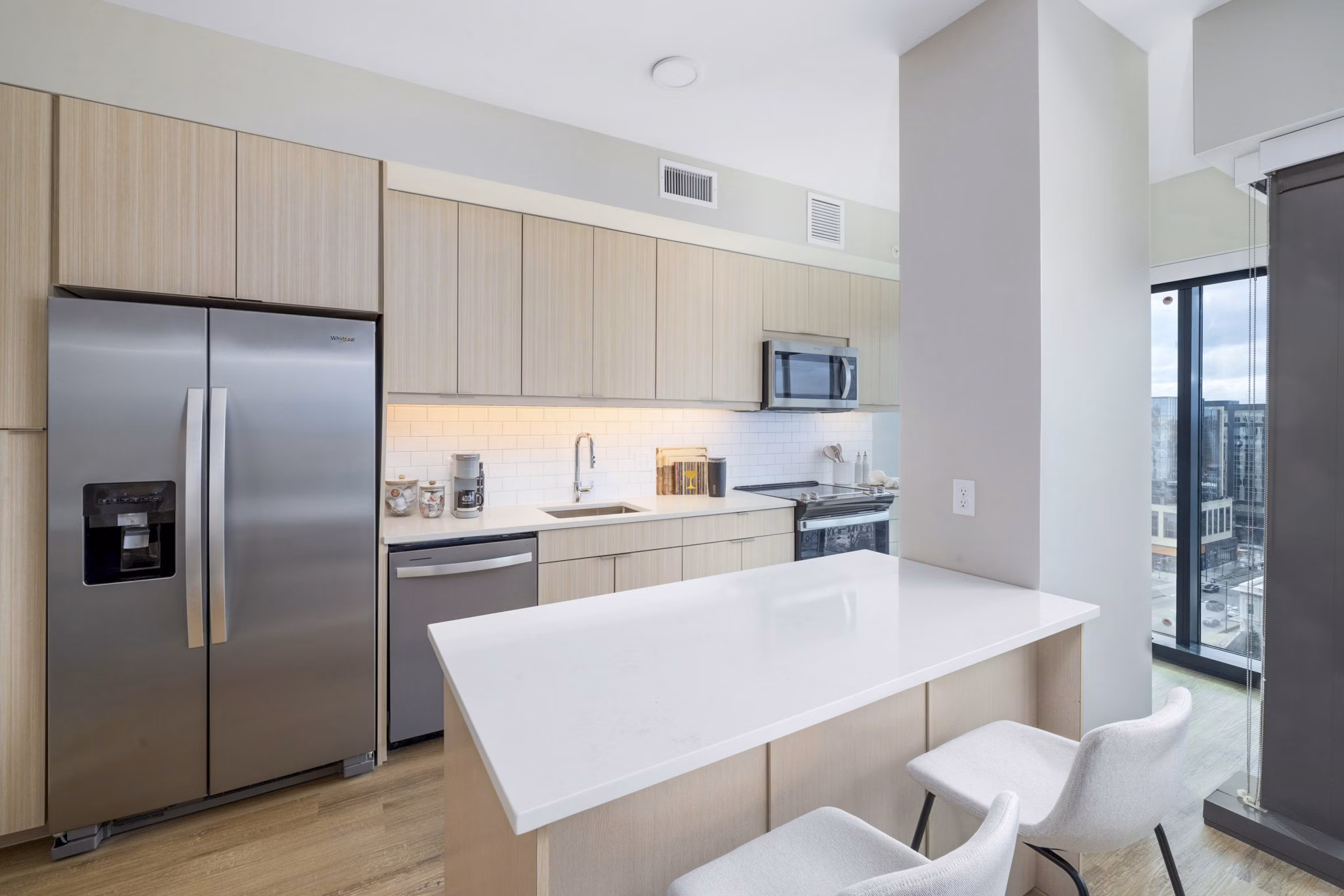Modern kitchen with sleek countertops and stainless steel appliances at 400H Apartments luxury homes by Greystar