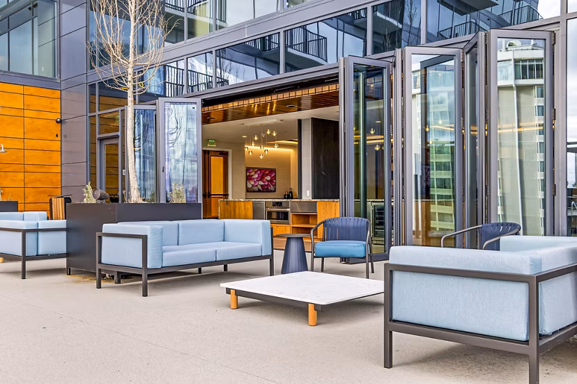 Spacious patio with modern furniture at 400H Apartments, perfect for outdoor relaxation and gatherings in urban setting
