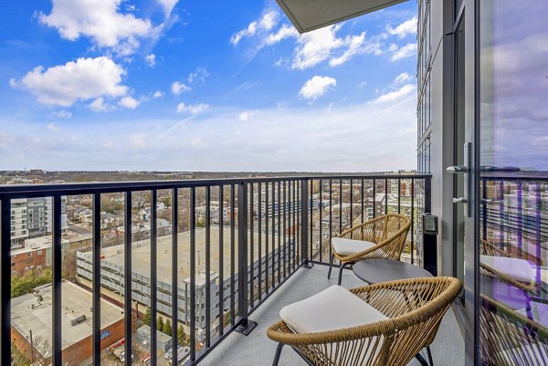 Spacious patio with modern seating at 400H Apartments offering city skyline views