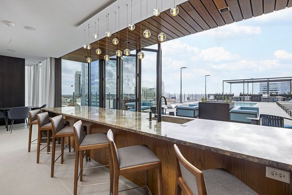 Stylish outdoor patio area at 400H Apartments, featuring modern seating and lush greenery